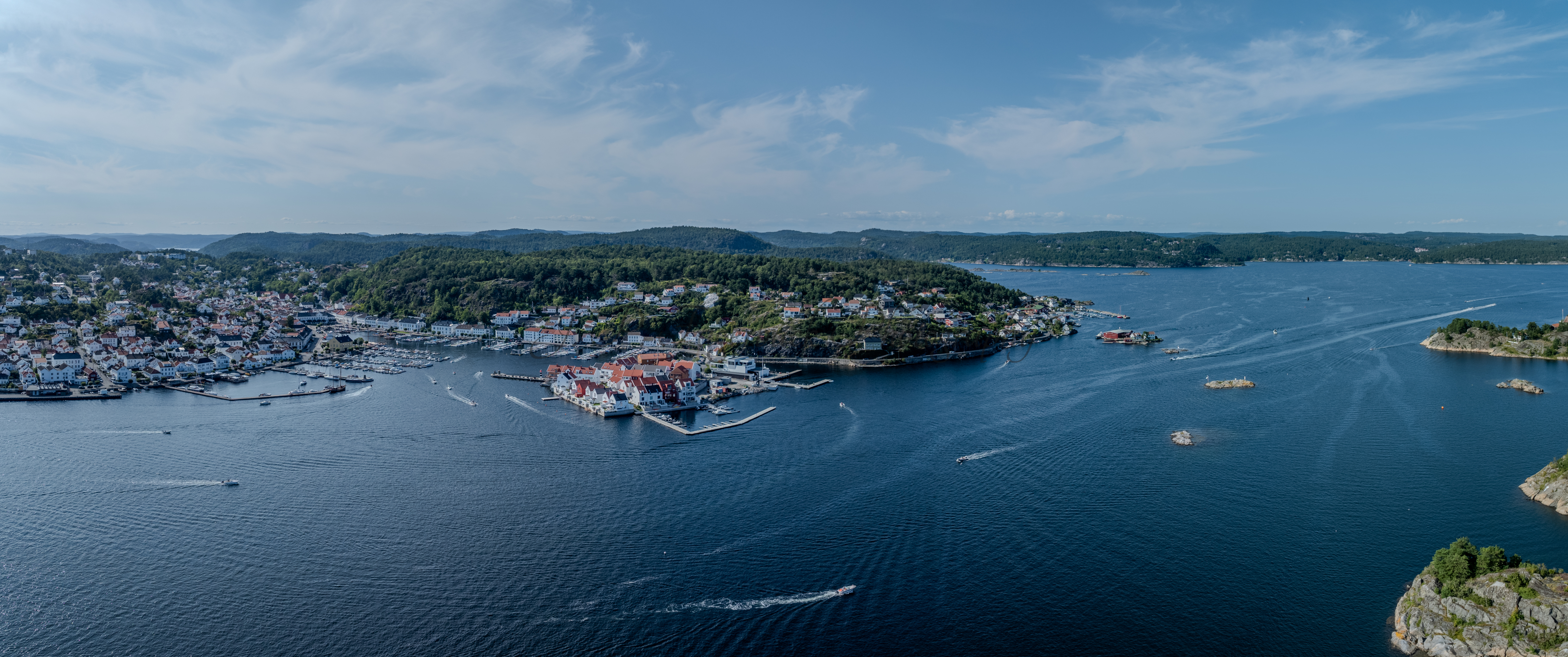 A panorama view of a town with small white houses along a shoreline