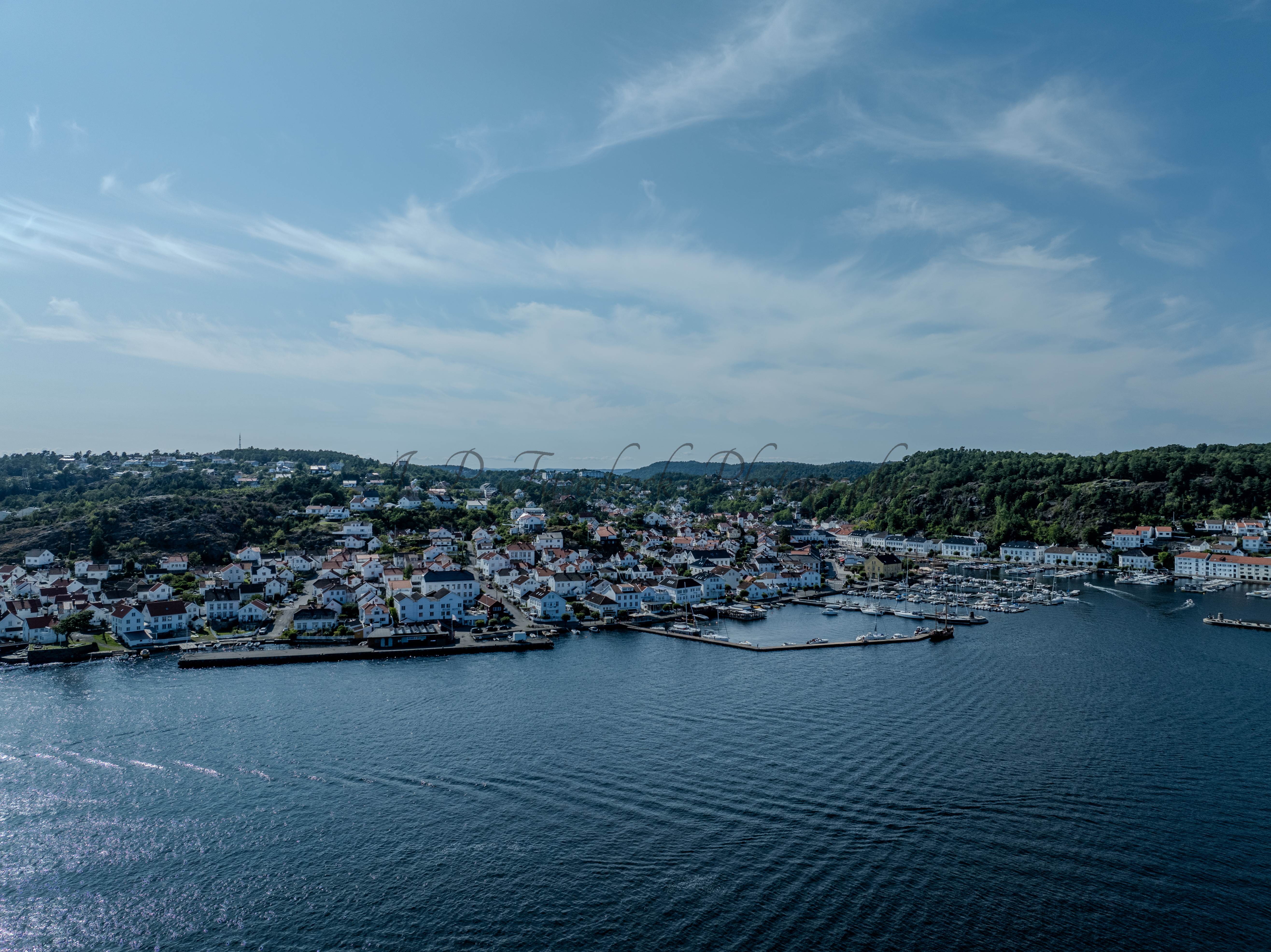 A town with small white houses along a shoreline