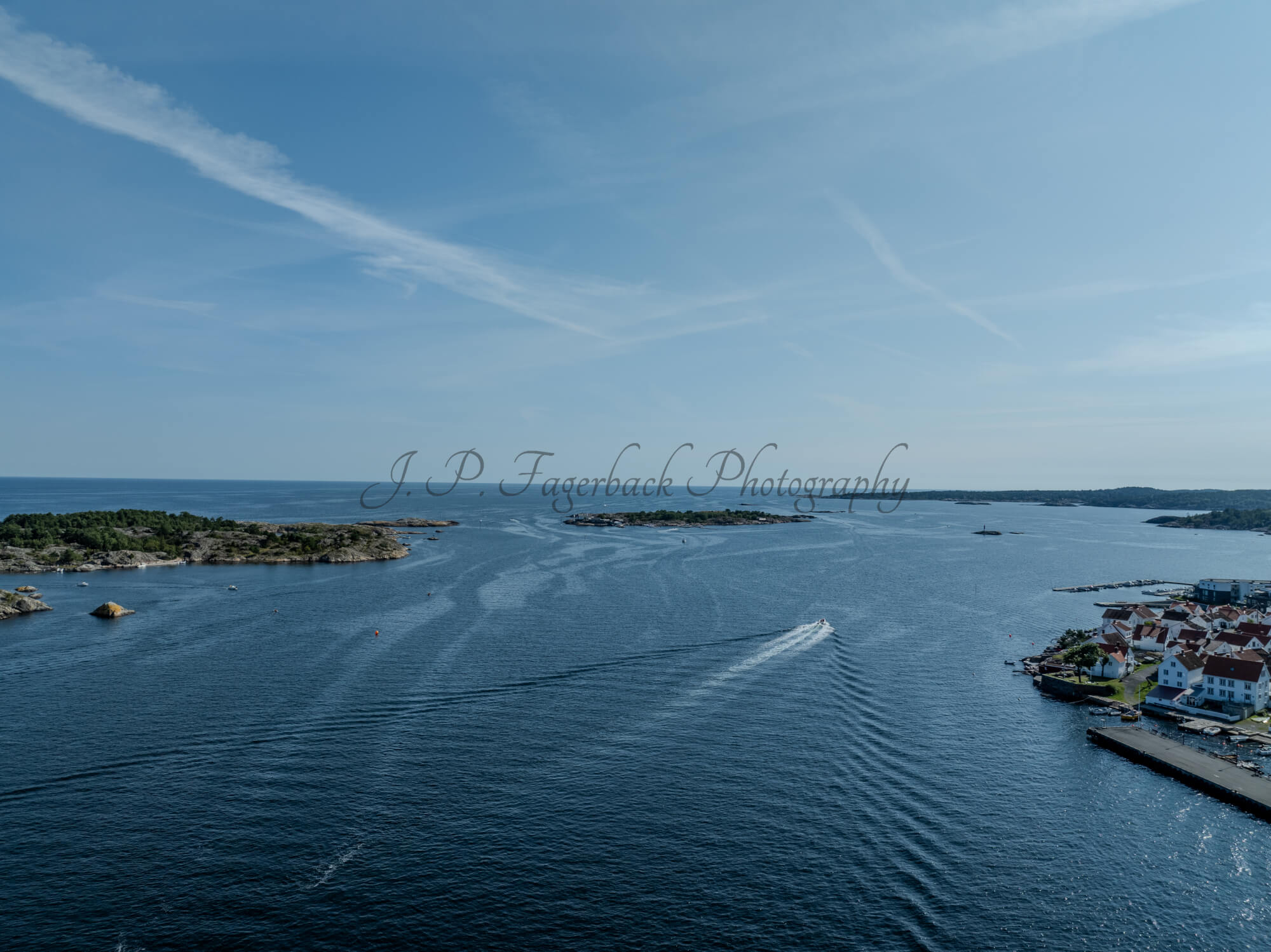 Islands with green vegitaions in sourounded by blue ocean water under a blue sky